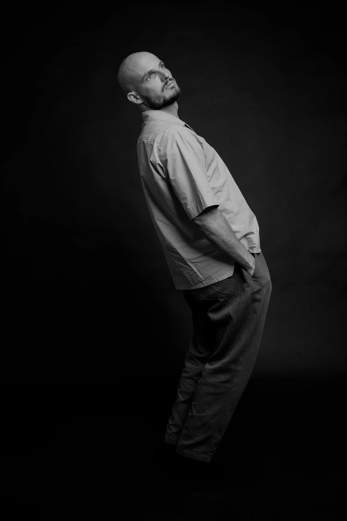 Cameron Jones leaning back in a black and white studio portrait